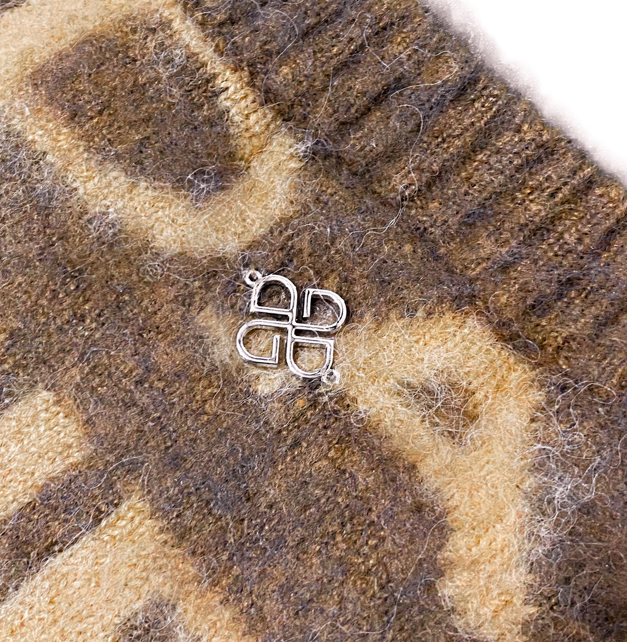 Udarkie metallic pin on a brown mohair sweater