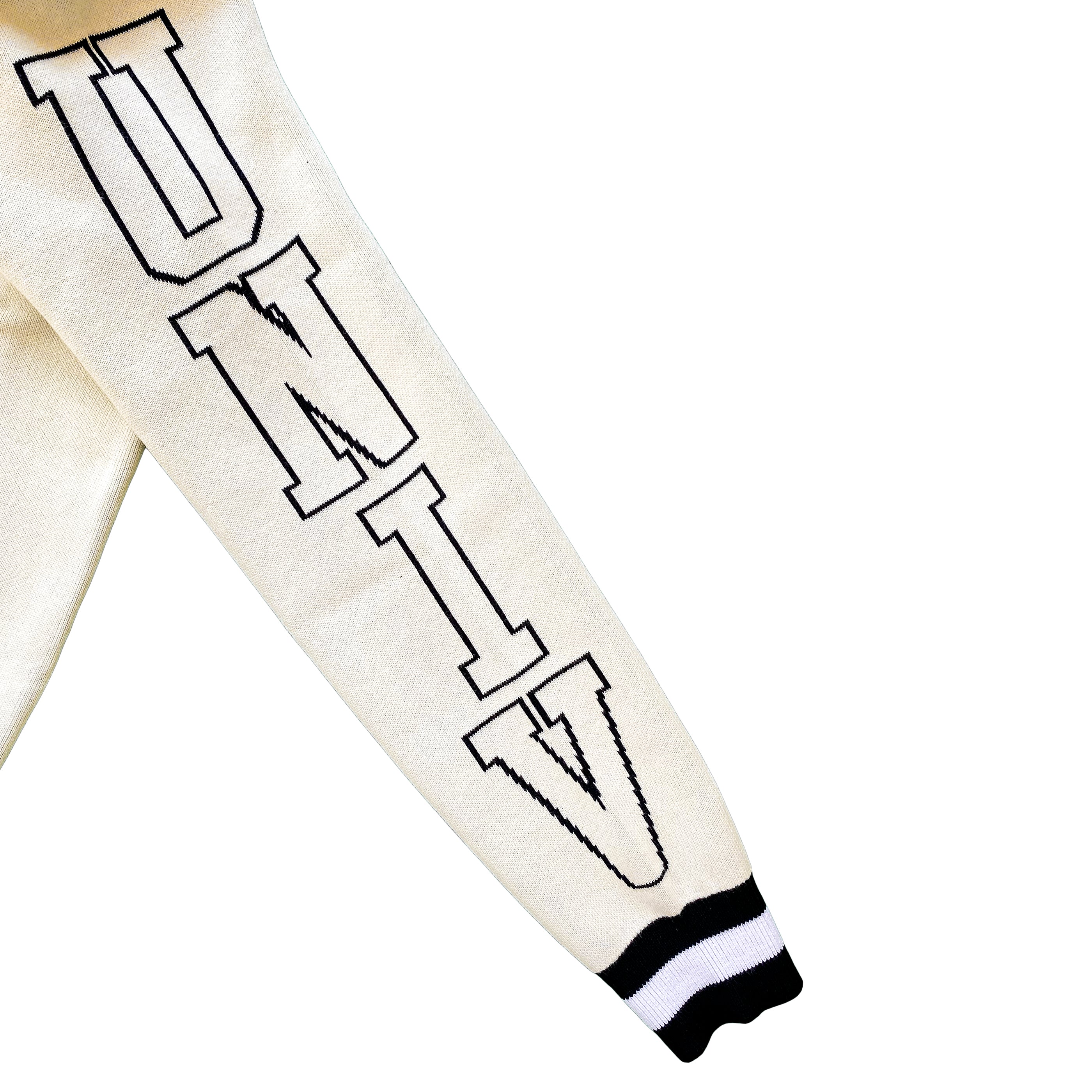 Close-up of a cream white varsity-style jacket sleeve with white printed "UNIV" text