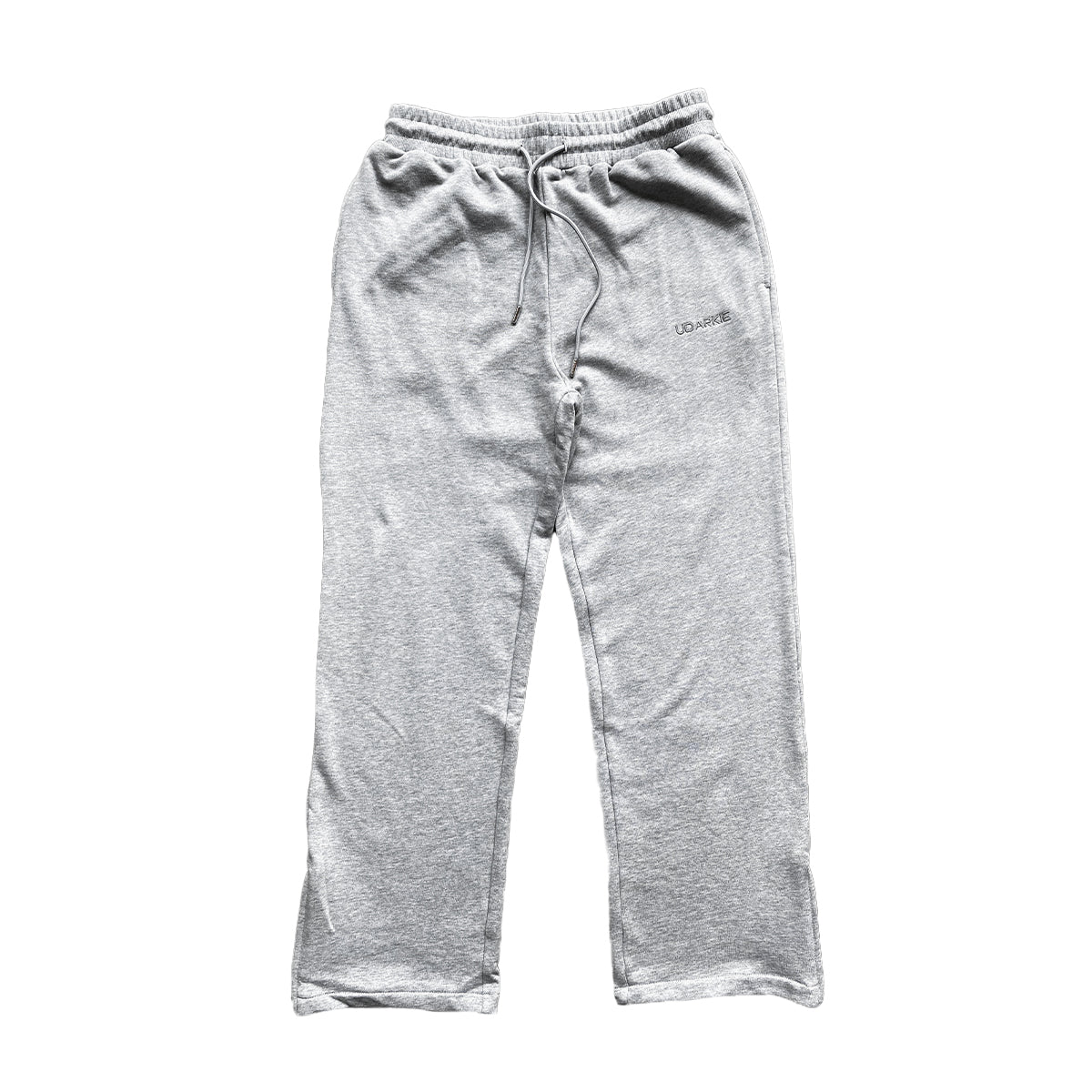 Folded gray trackpants with elastic waistband and drawstring, with "UDARKIE" branding on the upper left thigh.