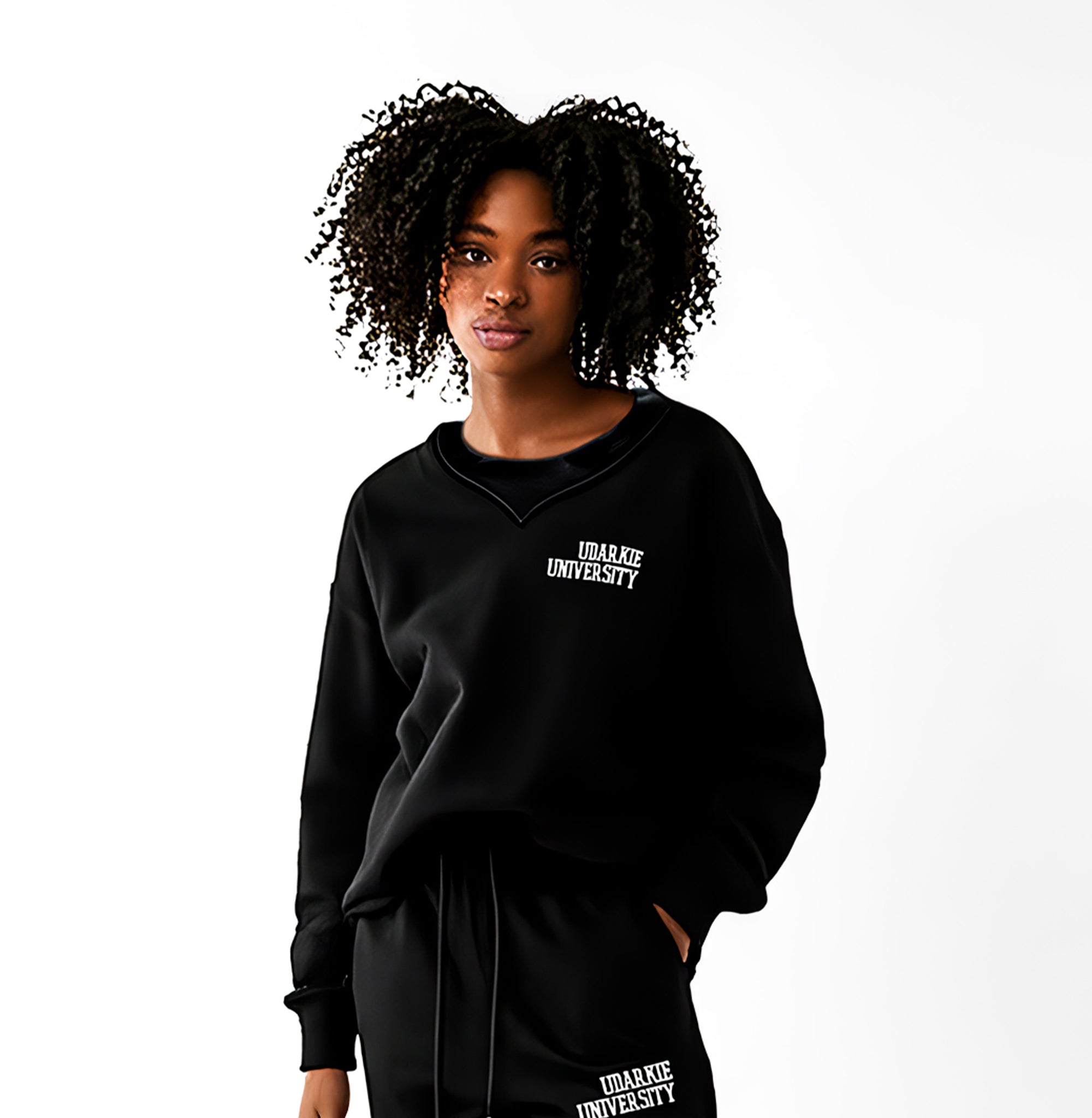woman wearing black sweatshirt and sweatpants with white "UDARKIE UNIVERSITY" logo.