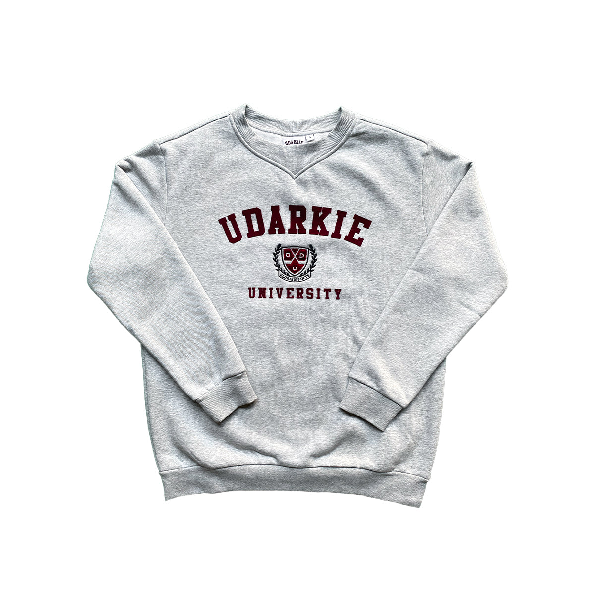 Grey sweatshirt with "UDARKIE UNIVERSITY" in maroon letters and a crest emblem with shield and laurel branches