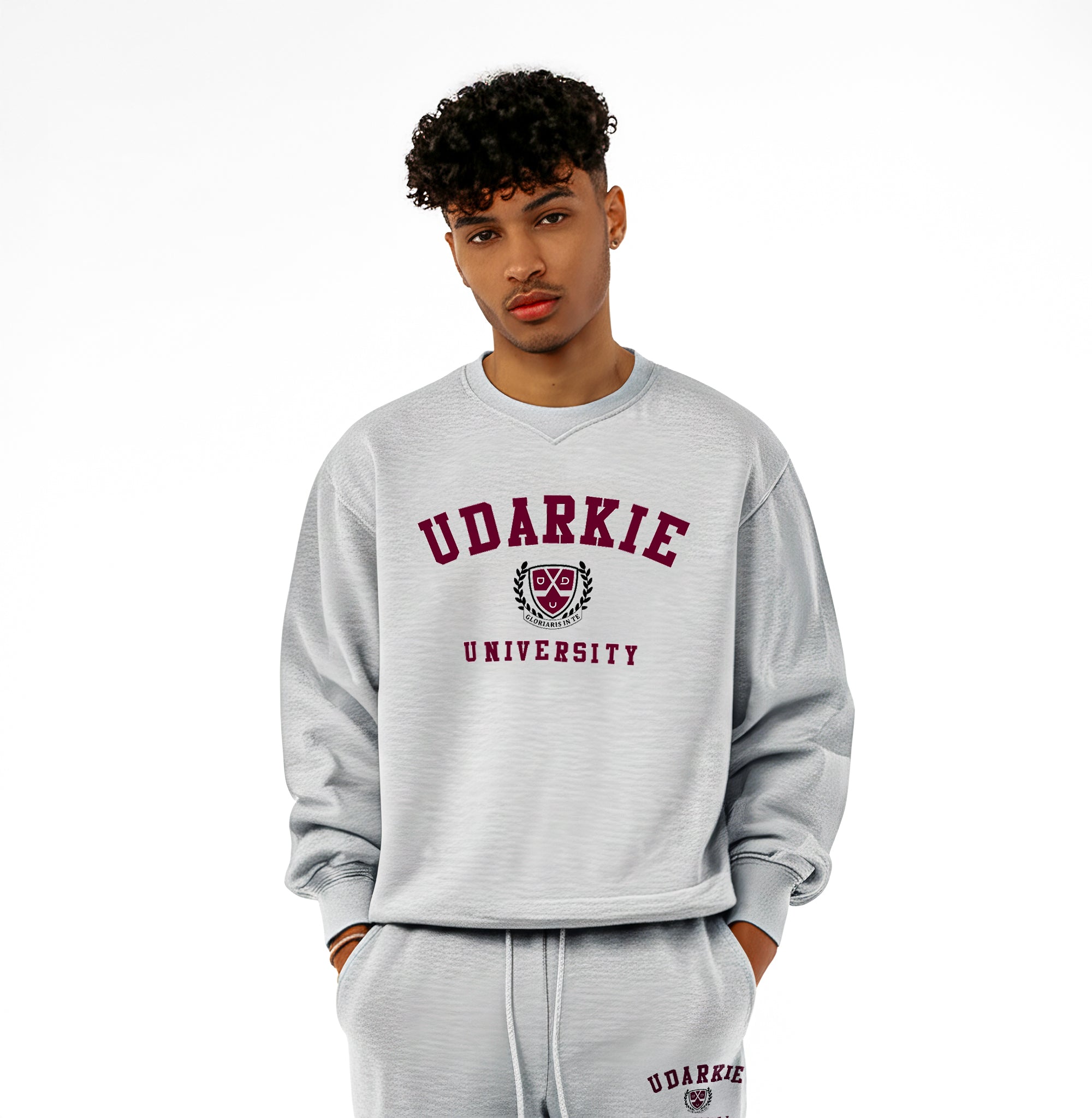 Front view of gray UDARKIE UNIVERSITY sweatsuit with a maroon text and emblem on both sweatshirt and sweatpants