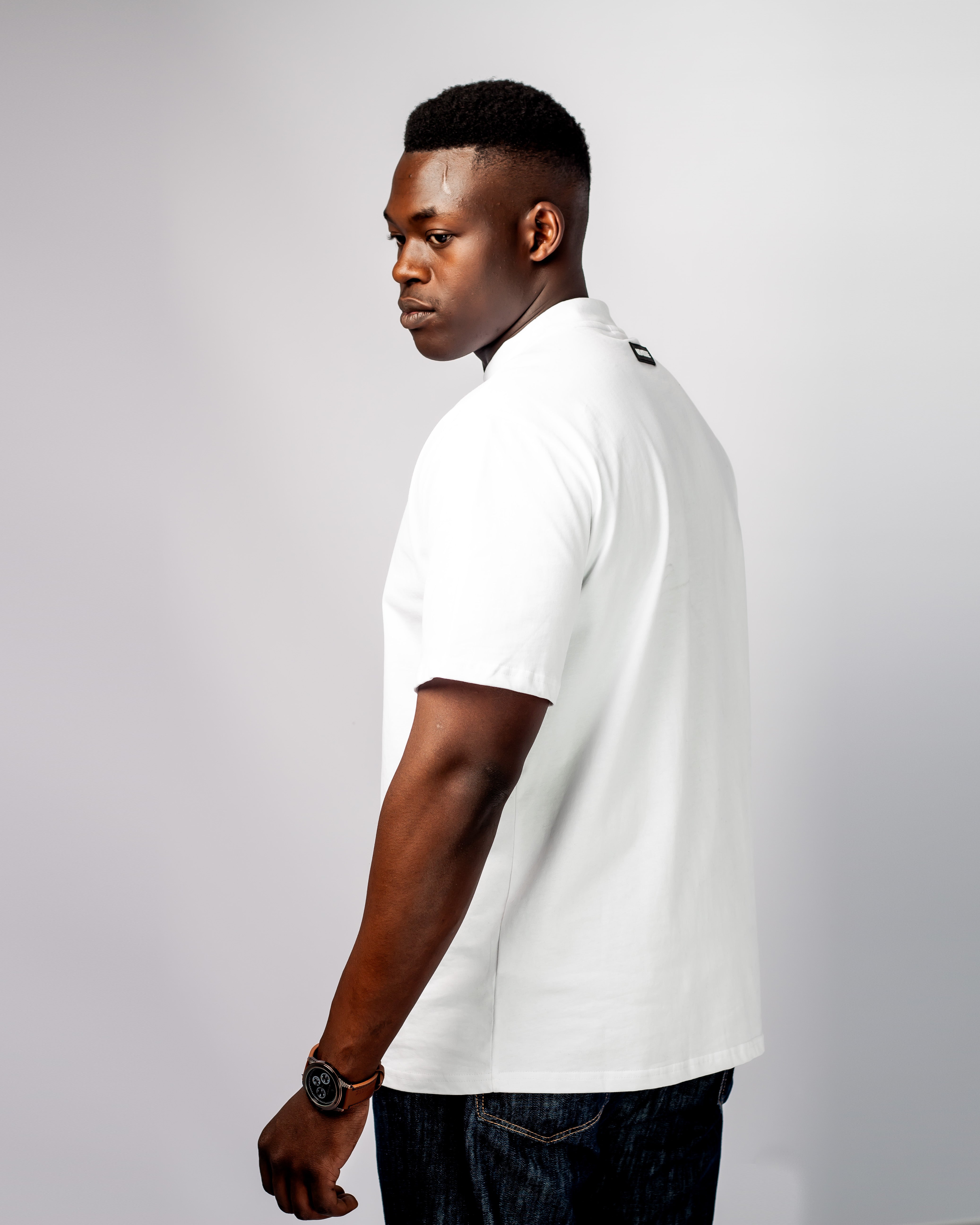 Back view of a UDARKIE white tshirt u are print with short sleeves and crew neck, featuring a small black "UDARKIE" label near the neckline.