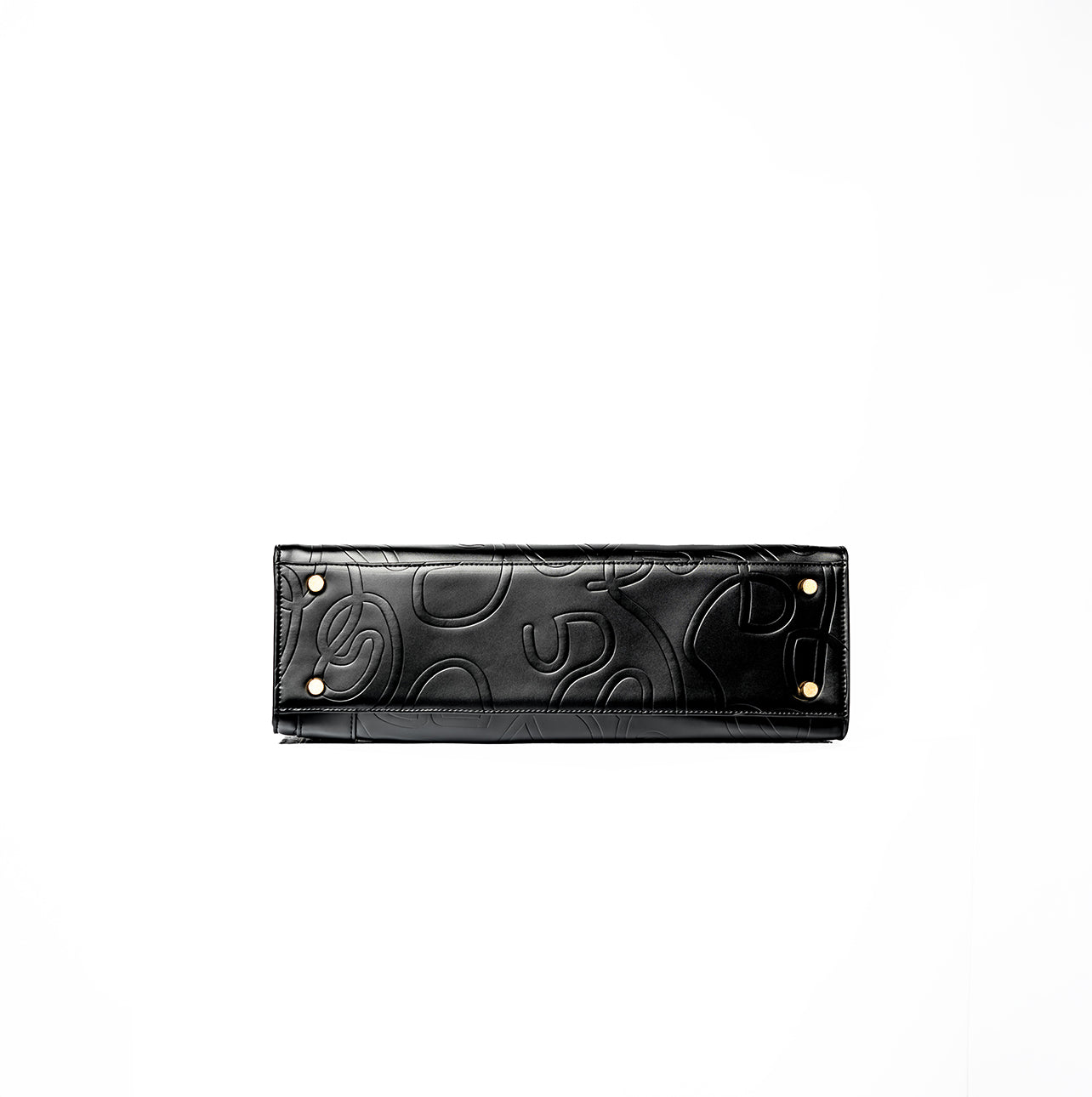 Bottom view of a black UDARKIE handbag with embossed abstract patterns and four metal studs at the corners. Rectangular shape with visible stitching for durability and style.