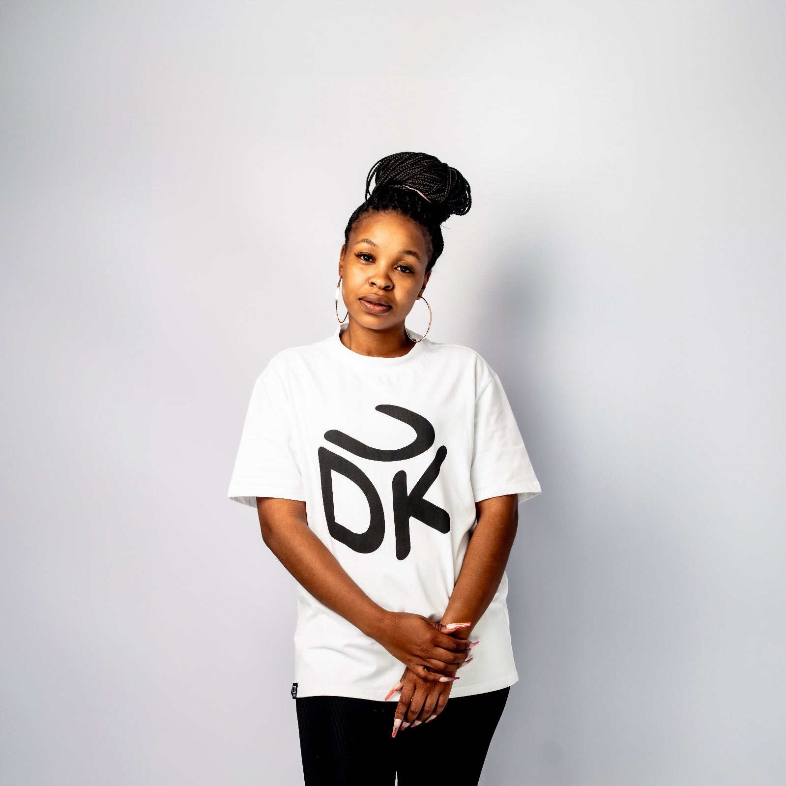 White T-shirt with short sleeves and round neckline, featuring a white stylized "UDK" box logo on the front.