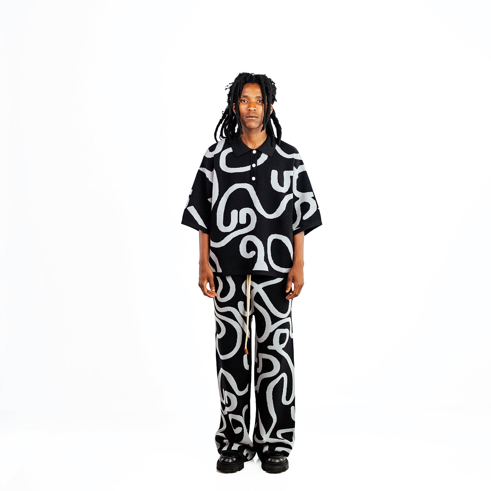 Men's knitted cotton black two-piece golfer outfit with white swirl print.