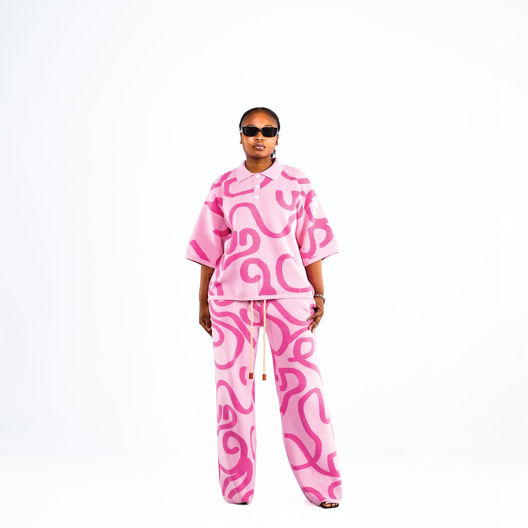 Women's knitted cotton pink pants outfit with white swirl print.