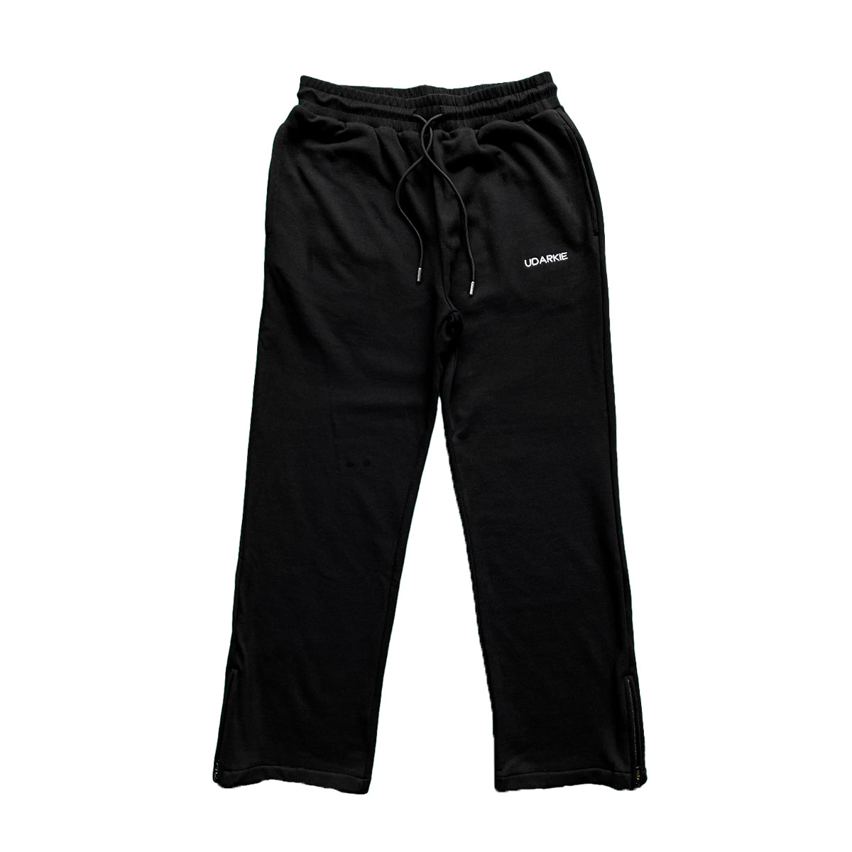 Black trackpants with elastic waistband and drawstring, with "UDARKIE" branding on the upper left thigh