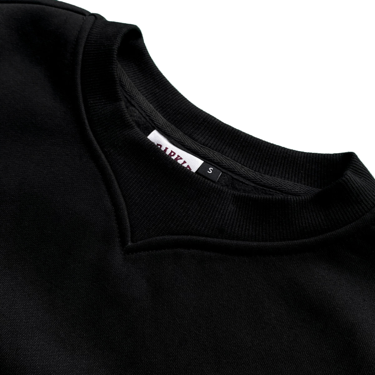 Close-up of black sweatshirt neckline with "UDARKIE" tag showing size.