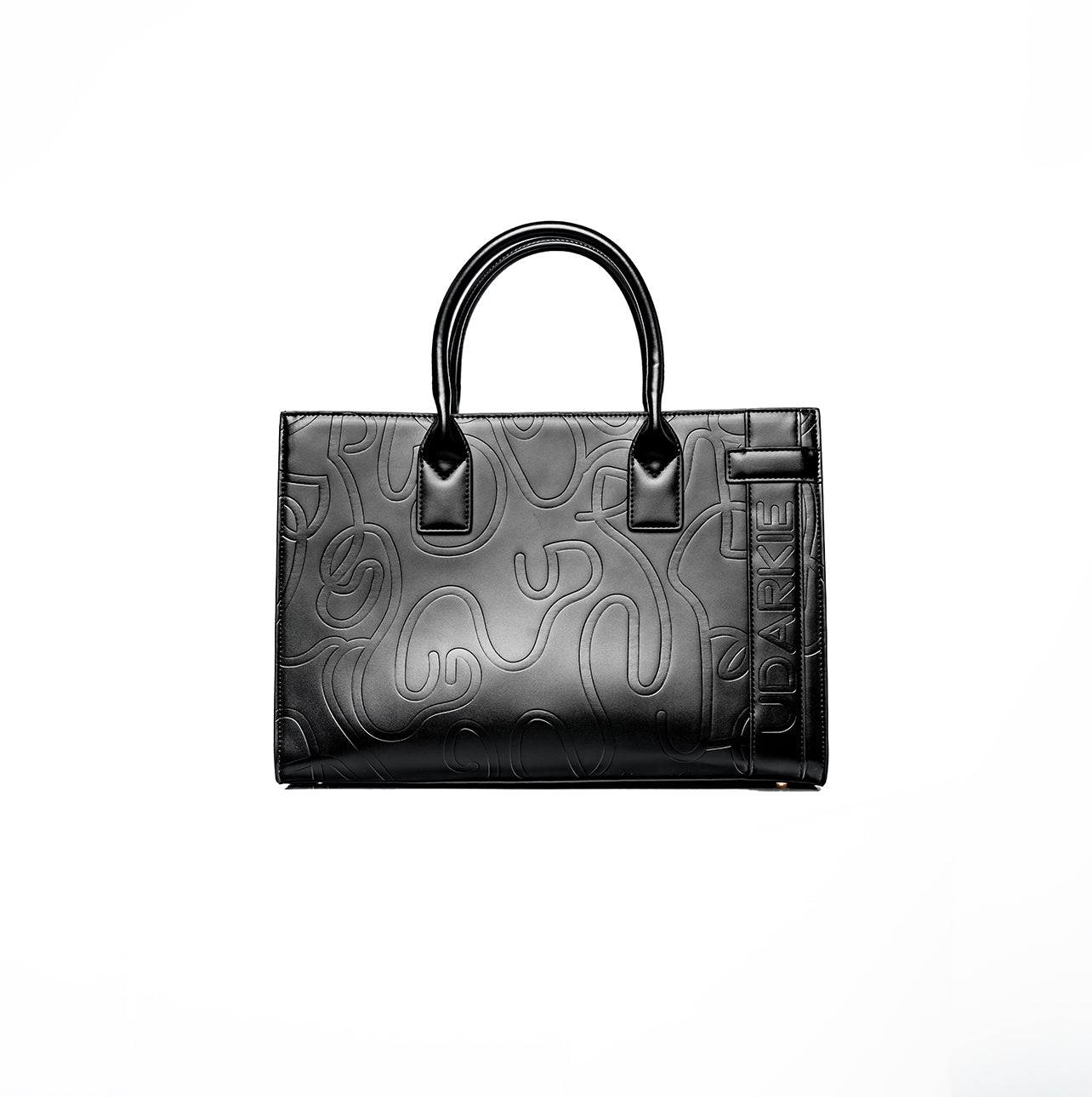 Black tote bag with two handles, featuring an embossed swirl pattern and a vertical strip with the text "UDARKIE" on the right side. Sleek and stylish design.