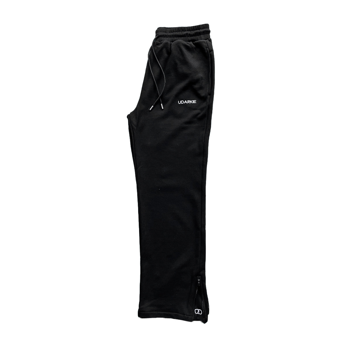 Folded black trackpants with elastic waistband and drawstring, with "UDARKIE" branding on the upper left thigh.